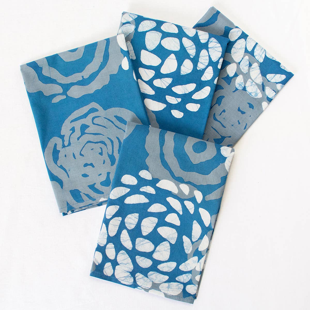 Organic Batik Napkins with Indigo Bloom pattern by Global Mamas, featuring vibrant blue and white handcrafted fabric.