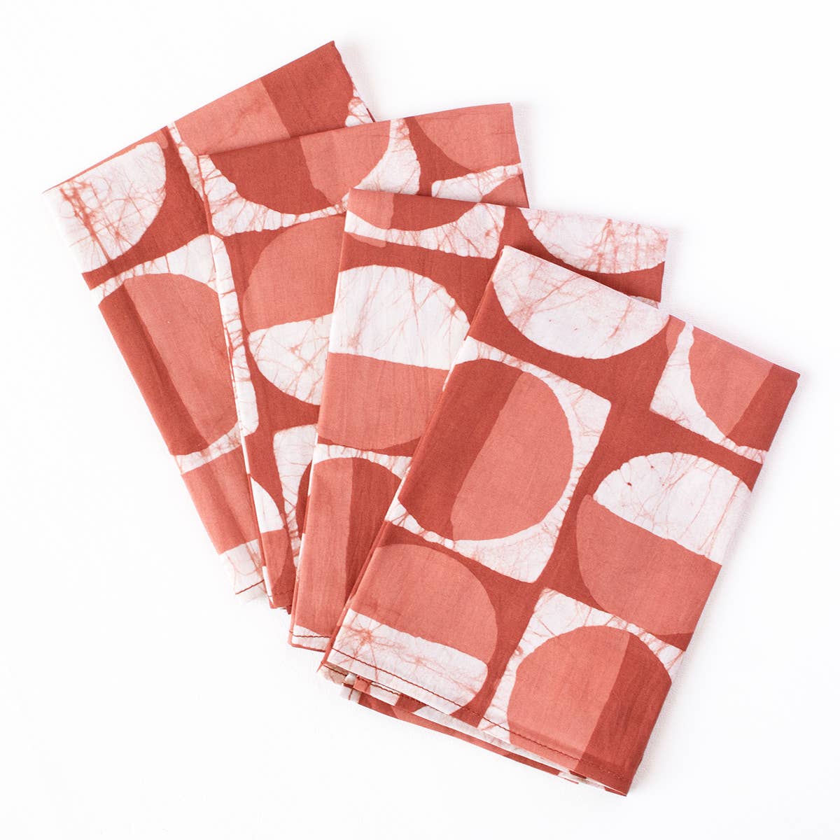 Set of four organic batik napkins with modern circle patterns from Global Mamas, showcasing colorful, handcrafted fabric design.