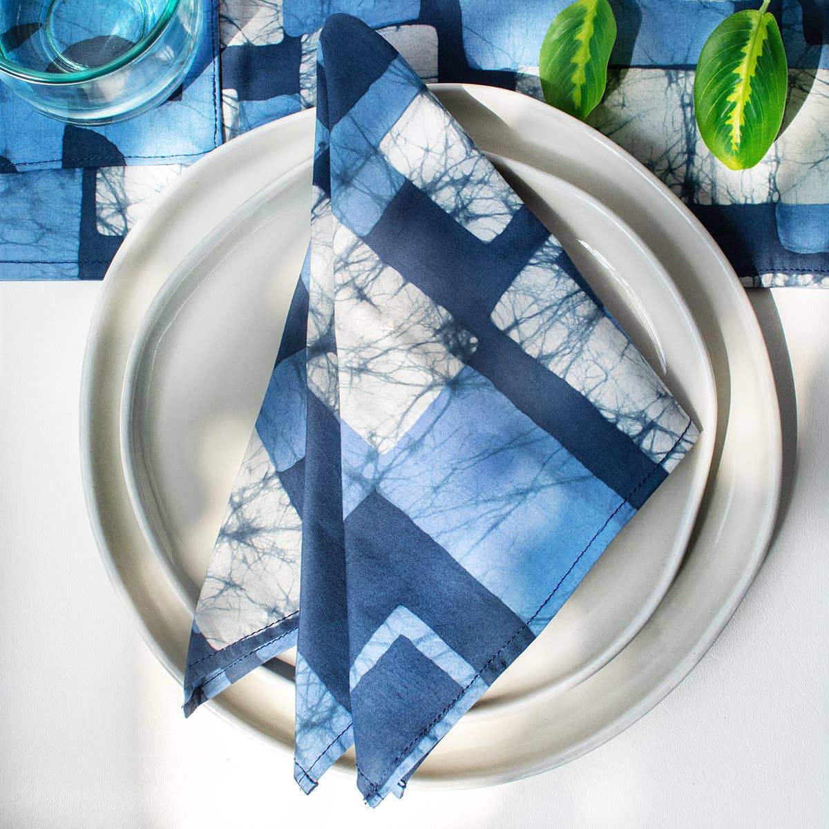 Organic Batik Napkins with navy block patterns by Global Mamas, showcasing vibrant, hand-dyed fabric with intricate batik designs.