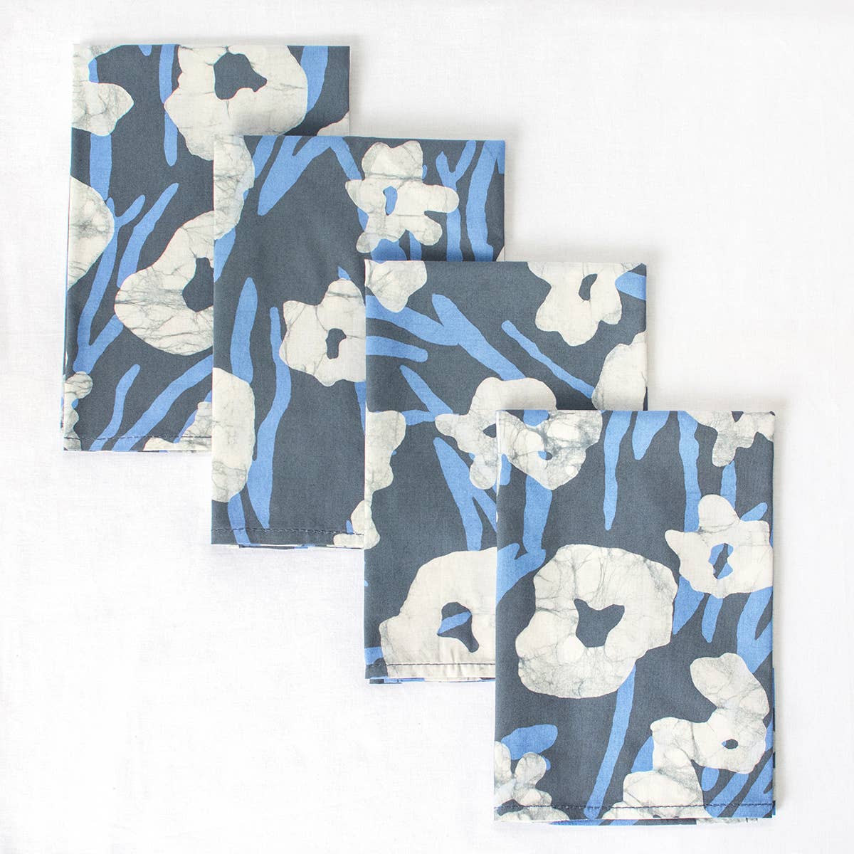 Organic Batik Napkin with painted floral design by Global Mamas, showcasing vibrant colors and intricate batik fabric pattern.
