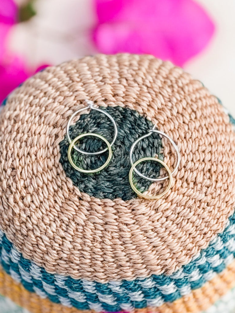 Sterling silver hoop earrings with small brass circle charms