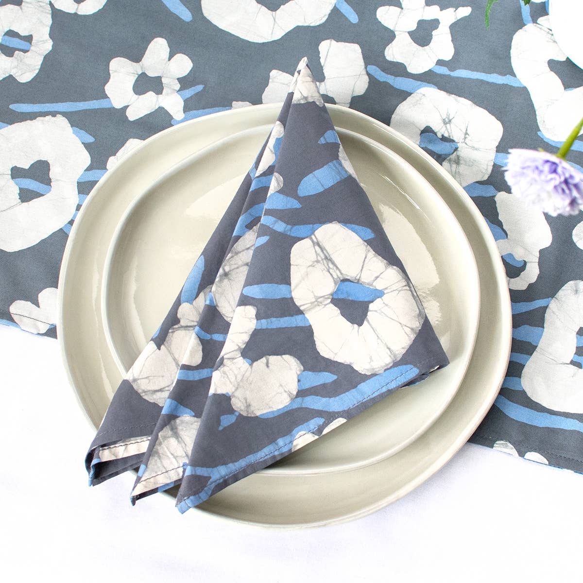 Organic Batik Napkin with painted floral design by Global Mamas, showcasing vibrant colors and intricate batik patterns.